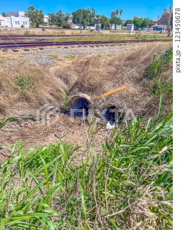 Two side-by-side concrete stormwater culverts under train railroad tracks Two side-by-side concrete stormwater culverts under train railroad tracks 123450678