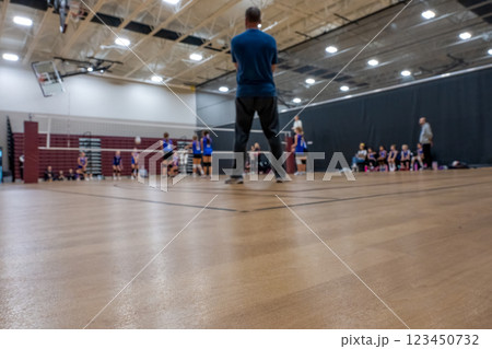 low level selective focus on gym floor at a youth volleyball match  123450732