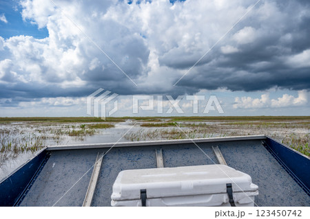 View from inside the front of an airboat in the everglades of Florida with grass and wetland swamp in the background 123450742