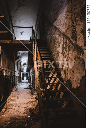 decrepit cell block and stairs leading to upper level at Eastern State Penitentiary historic site. 123450773