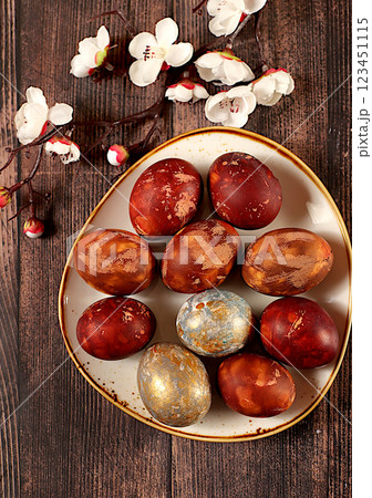 Easter celebration concept, Easter marble eggs dyed with natural onion peel and curcumin, with sakura branch on wooden gray background. holiday card and ideas for preparing for the great holiday Easter celebration concept, Easter marble eggs dyed with natural onion peel and curcumin, with sakura branch on wooden gray background. holiday card and ideas for preparing for the great holiday 123451115