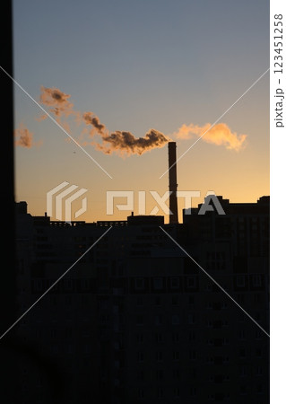The beautiful silhouette of a Factory Chimney is clearly visible against a stunning sunset 123451258