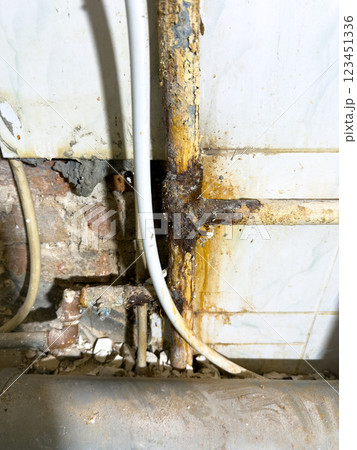 Closeup view of wood rot present at plumbing joints, which highlights extensive water damage and deterioration Closeup view of wood rot present at plumbing joints, which highlights extensive water damage and deterioration 123451336