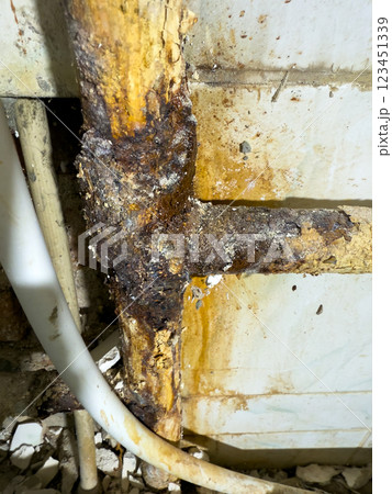 Closeup view of strong rust present at plumbing joints, which highlights extensive water damage and deterioration Closeup view of strong rust present at plumbing joints, which highlights extensive water damage and deterioration 123451339
