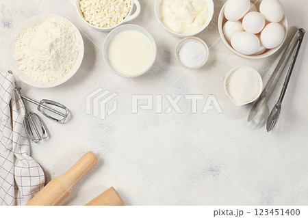Frame for baking and making cake, bread, confectionery and ingredients for cooking, milk, flour, salt, sugar, eggs and cream on a concrete background with space for text, selective focus, top view Frame for baking and making cake, bread, confectionery and ingredients for cooking, milk, flour, salt, sugar, eggs and cream on a concrete background with space for text, selective focus, top view 123451400