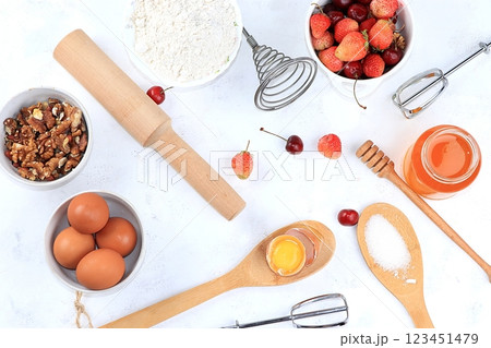 Kitchen background, cooking, Strawberry cherry pie recipe. Eggs, flour, sugar, strawberries and honey, top view, flat lay. Bakery background, modern bakery concept, selective focus 123451479