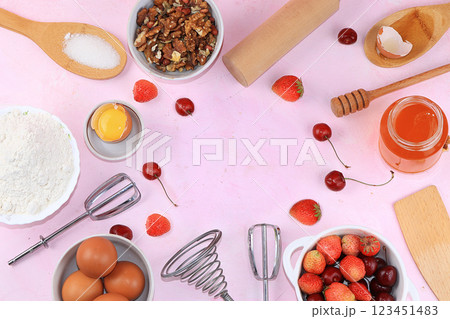 The recipe for making strawberry cherry pie. Eggs, flour, Sazar, strawberries and honey, top view, flat lay. Background of bakery products, the concept of a modern bakery The recipe for making strawberry cherry pie. Eggs, flour, Sazar, strawberries and honey, top view, flat lay. Background of bakery products, the concept of a modern bakery 123451483