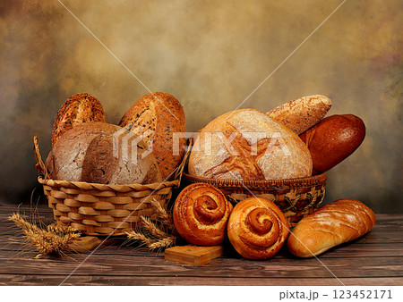 Freshly baked bakery products on wooden background. Whole grain homemade bread, different types of round sourdough bread with crispy crust, baguettes, buns and ears of wheat, modern baking concept, 123452171