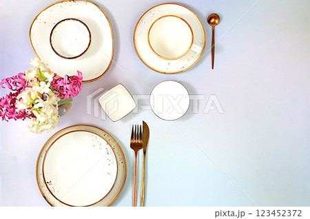 Elegant festive table setting. Cutlery with flowers on a plate on a marble background., menu layout in a cafe or restaurant, festive composition with a bouquet of hyacinths, kitchen background. Elegant festive table setting. Cutlery with flowers on a plate on a marble background., menu layout in a cafe or restaurant, festive composition with a bouquet of hyacinths, kitchen background. 123452372