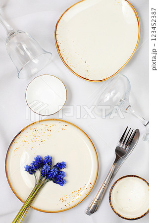 Elegant festive table setting. Set of beautiful cutlery with spring muscari on a marble background, menu layout in a cafe or restaurant, festive composition with a bouquet of hyacinths, kitchen 123452387