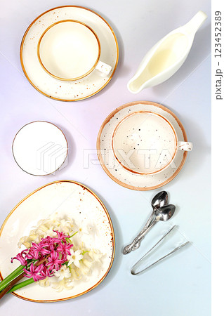 Elegant festive table setting, menu layout in a cafe or restaurant, cutlery with flowers on a plate on a marble background, festive composition with a bouquet of hyacinths, kitchen background. 123452389