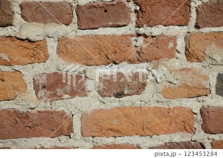 A textured wall made of bricks featuring beautiful and warm earthy tones throughout A textured wall made of bricks featuring beautiful and warm earthy tones throughout 123453284