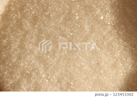 Closeup of granulated brown sugar, highlighting its fine texture and unique qualities 123453302
