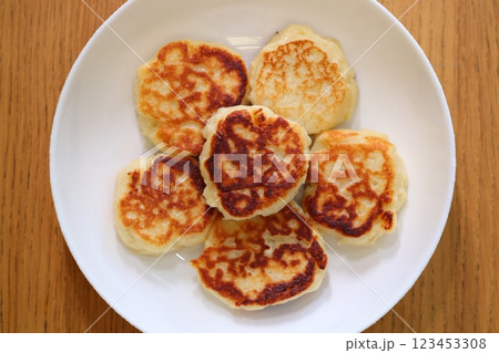 Indulge in the flavorful experience of Delicious Homemade Pancakes arranged on a White Plate 123453308