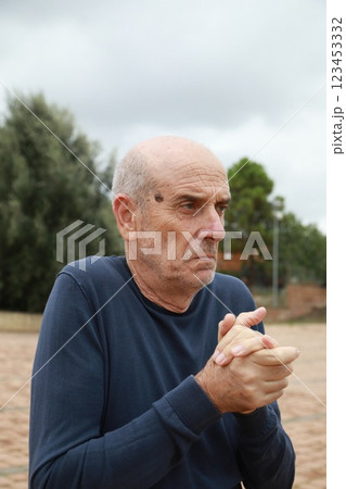Poor and Cold Elderly Man Tries to Take Shelter Under a Tree in Cold Winter Poor and Cold Elderly Man Tries to Take Shelter Under a Tree in Cold Winter 123453332