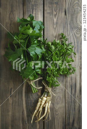 parsley with green leaves and celery on a wooden background, farm vegetables. parsley, herb. flavoring food. parsley with green leaves and celery on a wooden background, farm vegetables. parsley, herb. flavoring food. 123454255