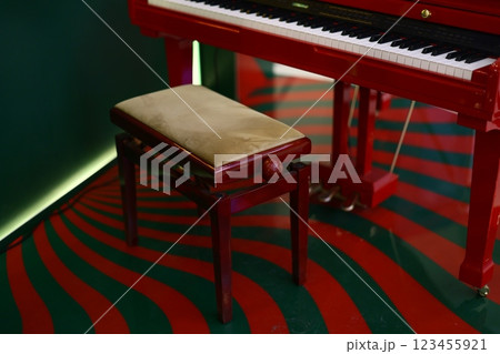Beautifully Elegant Red Piano Paired with a Matching Bench in Unique and Artistic Interior Setup Beautifully Elegant Red Piano Paired with a Matching Bench in Unique and Artistic Interior Setup 123455921