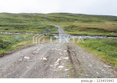 Gravel road across a stream in tundra Gravel road across a stream in tundra 123455941