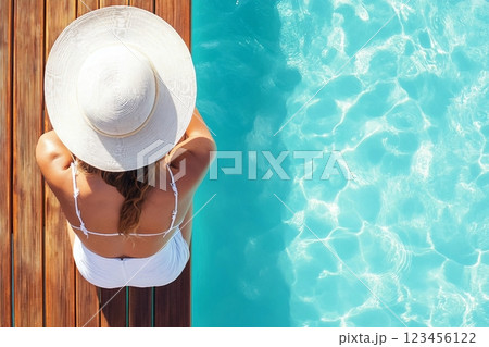Summer holiday fashion concept tanning woman wearing sun hat on a wooden pier view from above 123456122