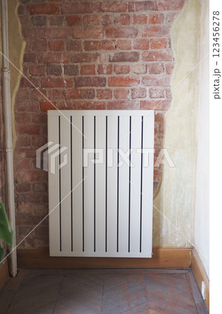An elegant radiator beautifully placed against an exposed brick wall for stunning decor style An elegant radiator beautifully placed against an exposed brick wall for stunning decor style 123456278