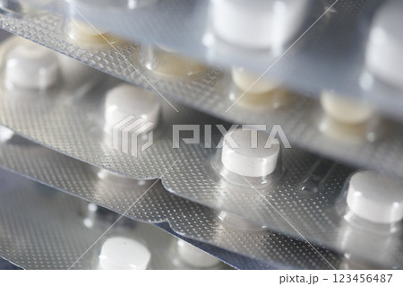 Close-up view of stacked medication tablets in blister packs 123456487