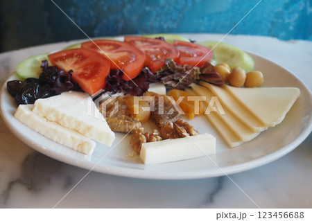 Fresh veggies and cheeses on a colorful platter await 123456688
