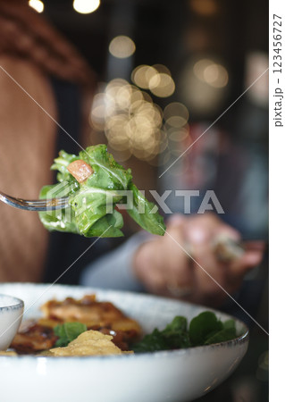 Fresh salad being enjoyed at a cozy restaurant setting during dinner 123456727