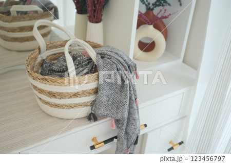 Decorative storage basket with a cozy scarf and warm decor elements 123456797
