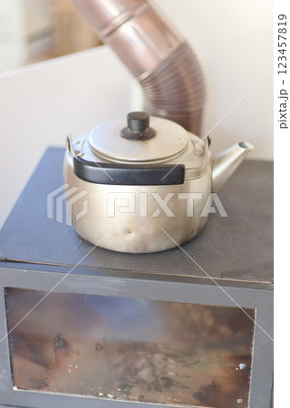 暖炉の上で温め中のやかん 123457819