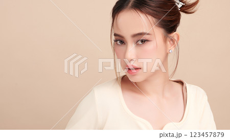 Beautiful young asian woman with clean fresh skin on beige background, Face care, Facial treatment, Cosmetology, beauty and spa, Asian women portrait. 123457879