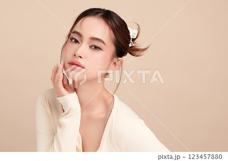 Beautiful young asian woman with clean fresh skin on beige background, Face care, Facial treatment, Cosmetology, beauty and spa, Asian women portrait. 123457880