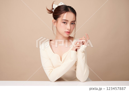 Beautiful young asian woman with clean fresh skin on beige background, Face care, Facial treatment, Cosmetology, beauty and spa, Asian women portrait. 123457887