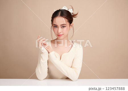 Beautiful young asian woman with clean fresh skin on beige background, Face care, Facial treatment, Cosmetology, beauty and spa, Asian women portrait. Beautiful young asian woman with clean fresh skin on beige background, Face care, Facial treatment, Cosmetology, beauty and spa, Asian women portrait. 123457888