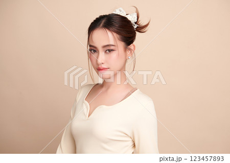 Beautiful young asian woman with clean fresh skin on beige background, Face care, Facial treatment, Cosmetology, beauty and spa, Asian women portrait. Beautiful young asian woman with clean fresh skin on beige background, Face care, Facial treatment, Cosmetology, beauty and spa, Asian women portrait. 123457893
