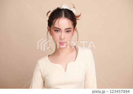 Beautiful young asian woman with clean fresh skin on beige background, Face care, Facial treatment, Cosmetology, beauty and spa, Asian women portrait. 123457894