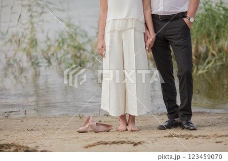 the bride and groom are standing in the water the bride and groom are standing in the water 123459070