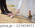 the bride and groom are standing in the water 123459071