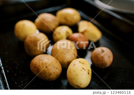 Washed unpeeled potatoes lie on a baking sheet 123460118