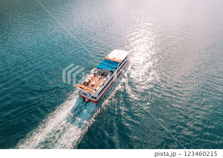 Double-decker excursion ship sails on the blue sea. Top view Double-decker excursion ship sails on the blue sea. Top view 123460215