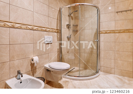Bidet and toilet hanging on the wall in the bathroom near the corner shower Bidet and toilet hanging on the wall in the bathroom near the corner shower 123460216