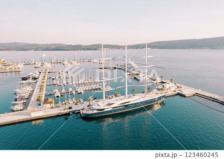 Large yacht with lowered sails stands at the marina pier. Drone Large yacht with lowered sails stands at the marina pier. Drone 123460245