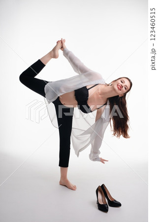 Woman showcasing beauty and elegance in lingerie during studio photoshoot 123460515