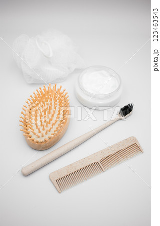 Body and hair care items on white background. Brush, comb, toothbrush, cream, loofah Body and hair care items on white background. Brush, comb, toothbrush, cream, loofah 123463543