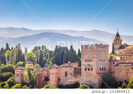 The Alhambra palace in Granada town in Spain. Ancient architecture nestled in a lush landscape, mountains providing a stunning backdrop. 123464411