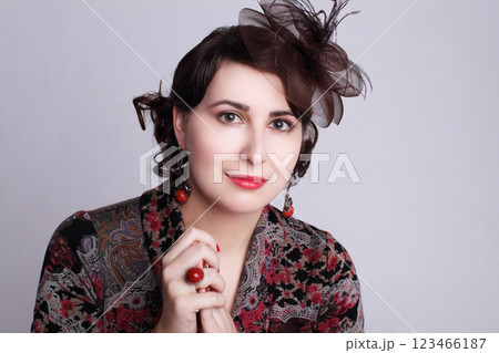Smiling brunette woman in red hat retro style fashion beauty portrait Smiling brunette woman in red hat retro style fashion beauty portrait 123466187