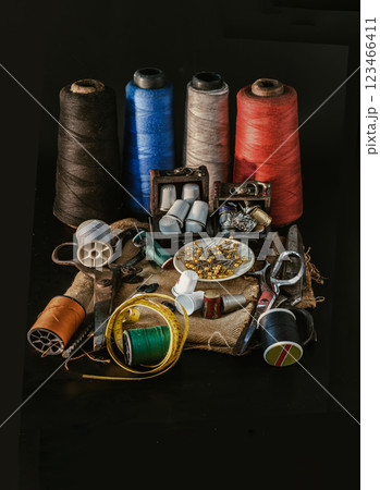 Thimbles in small wooden treasure chest, Spools of thread of various colour, Sewing needles stuck in a green miniature spools thread, Steel scissors and Measuring tape including pins in small round Thimbles in small wooden treasure chest, Spools of thread of various colour, Sewing needles stuck in a green miniature spools thread, Steel scissors and Measuring tape including pins in small round 123466411