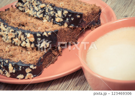 Fresh baked pastry made of zucchini and cup of white coffee. Delicious dessert Fresh baked pastry made of zucchini and cup of white coffee. Delicious dessert 123469306