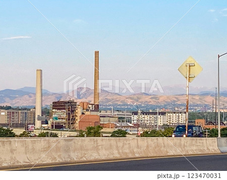 Industrial Landscape With Smokestacks with the Rocky Mountains in the Background During Clear Weather 123470031