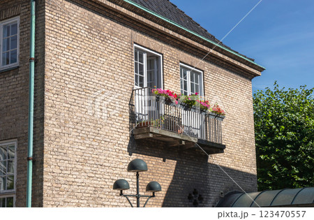 Cozy balcony with flowers in a brick house. 123470557