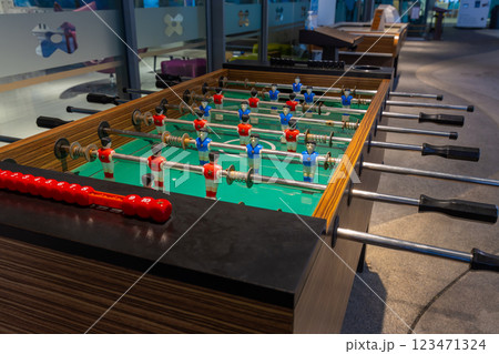 Retro table soccer with wooden miniature figurines of players on metal bars Retro table soccer with wooden miniature figurines of players on metal bars 123471324